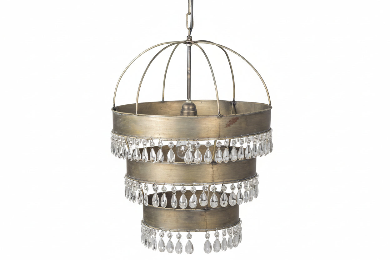 Decorative pendant light with crystal accents against a textured white wall.