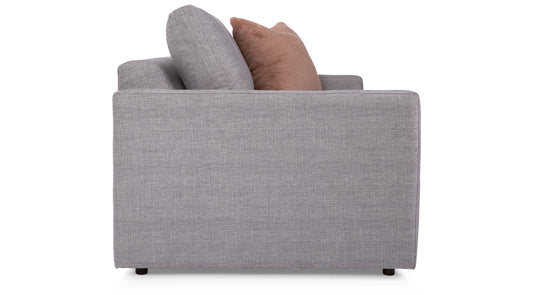 Gray sofa with two cushions on a white background