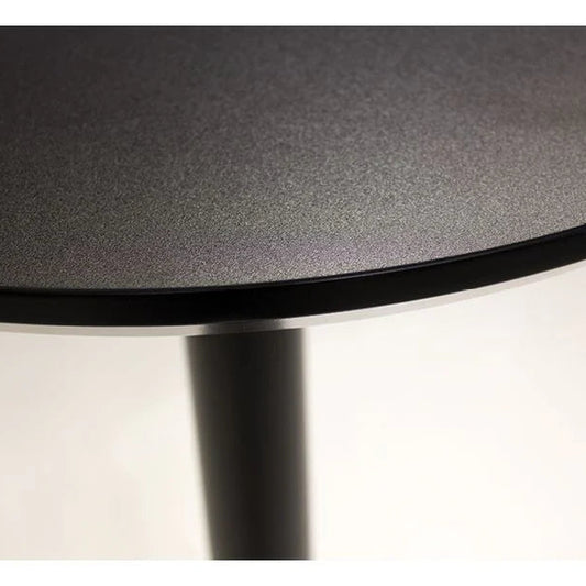 Close-up of a round black table with a white background