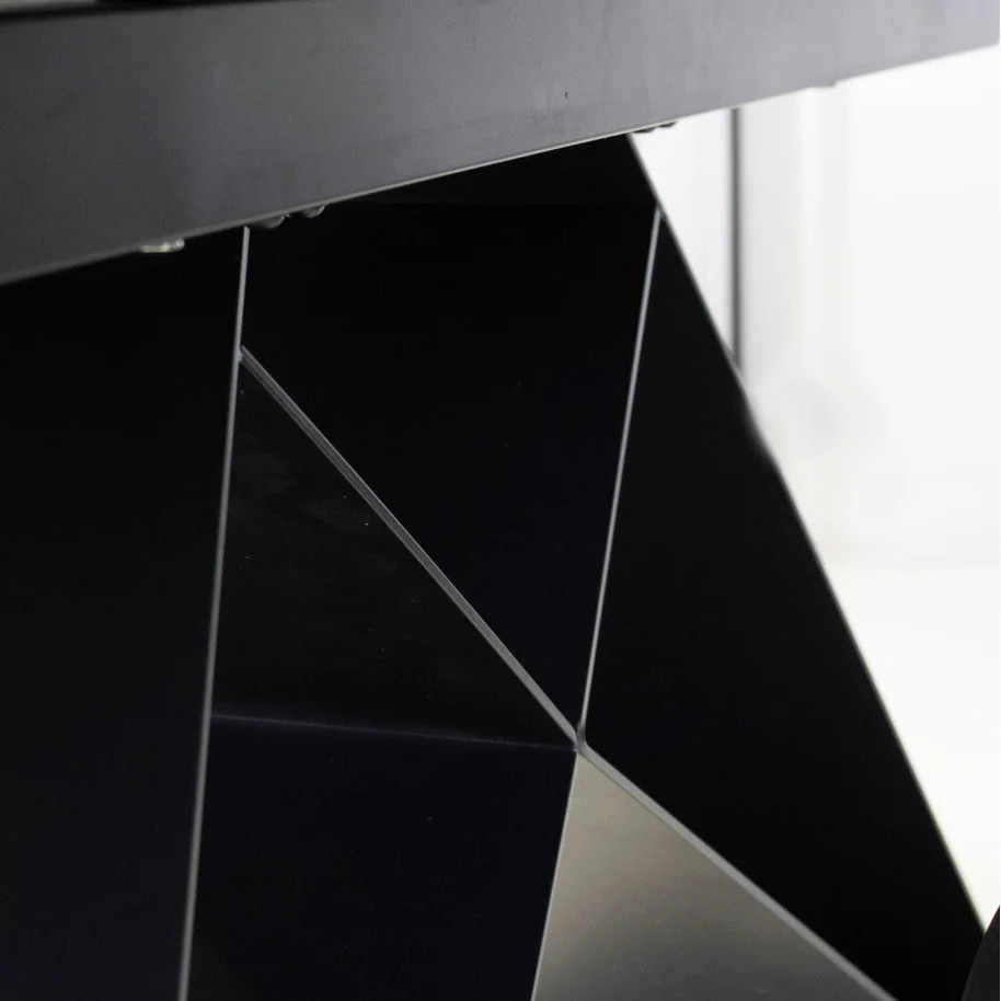 Close-up of a black metal table base with geometric design