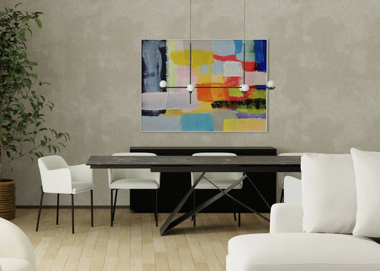 Modern living room with a dining table, chairs, and a colorful abstract painting on the wall.