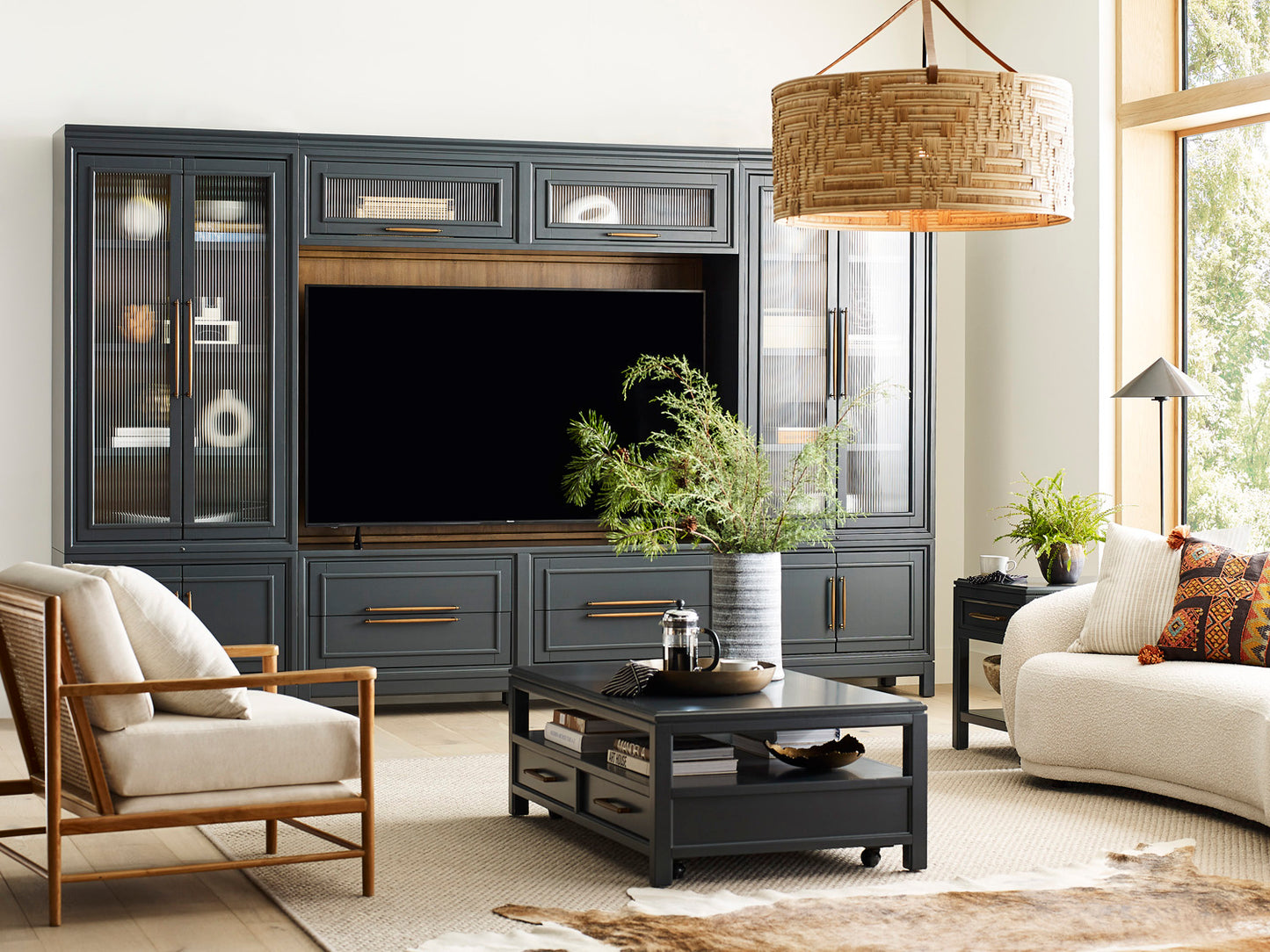 Living room with dark gray entertainment center, TV, and furniture.