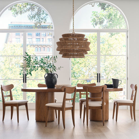 Dining room with wooden table and chairs near large windows