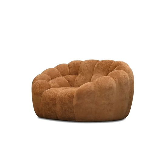 Brown quilted arm chair on a white background