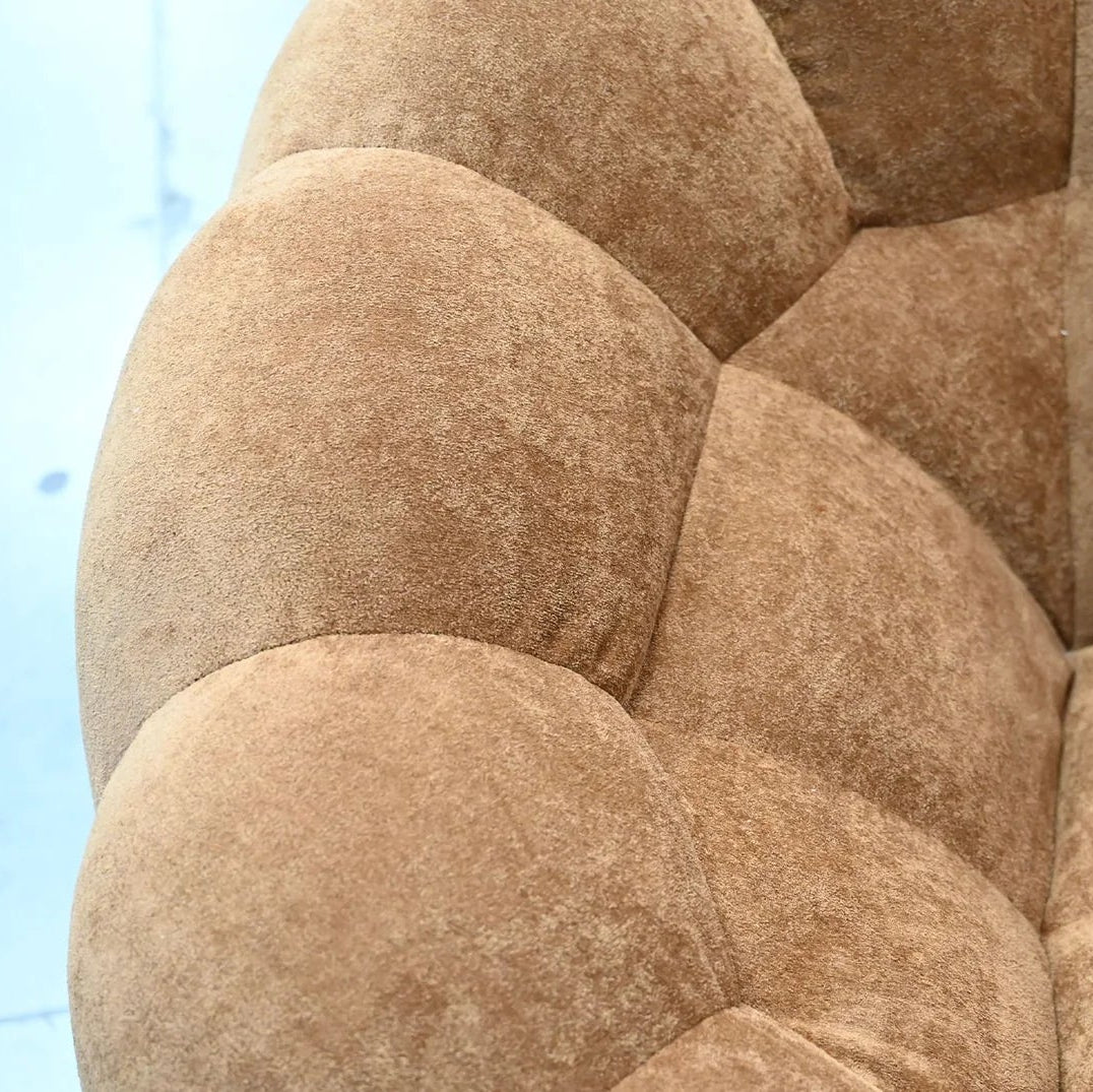 Close-up of a textured brown sofa with a blurred background