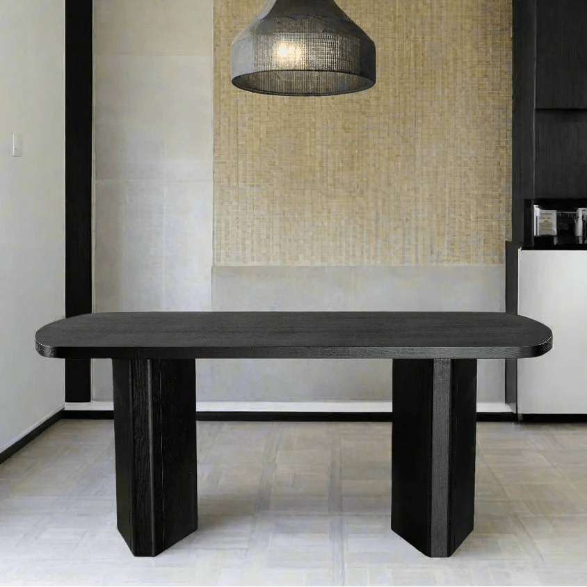 Modern dining table with a pendant light in a minimalistic room.