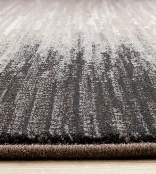 Textured gray rug on a light wooden floor
