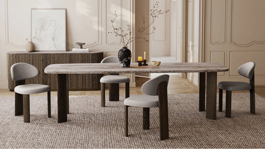 Dining room with a long wooden table and chairs in a stylish interior.