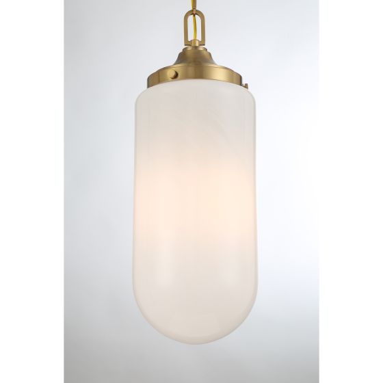 Pendant light with white glass shade and brass fixture on a light gray background