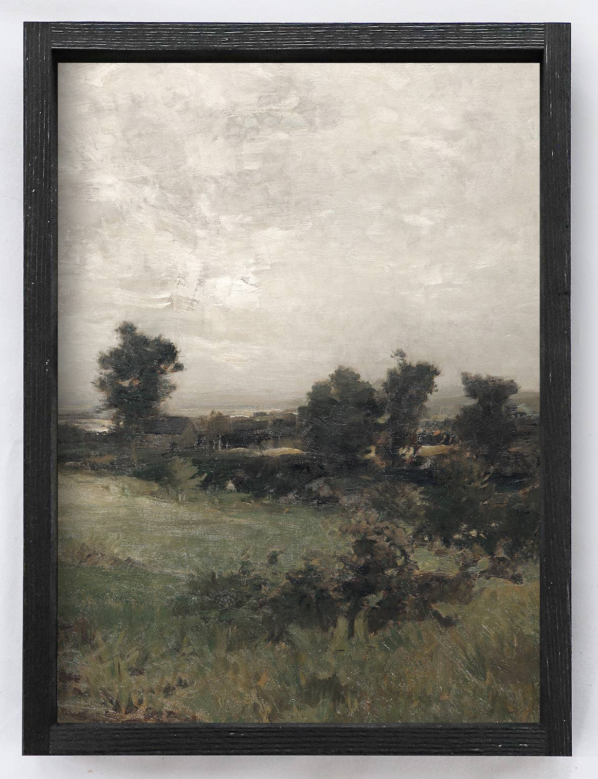 Framed landscape painting on a white wall