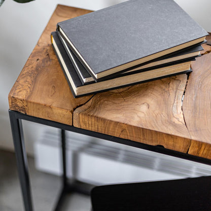 Stack of books on a wooden table with a blurred background