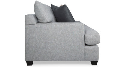 Gray sofa with two cushions on a white background
