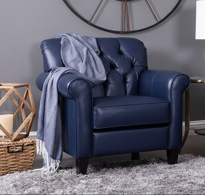 Living room with gray sofa, blue armchair, and round coffee table.