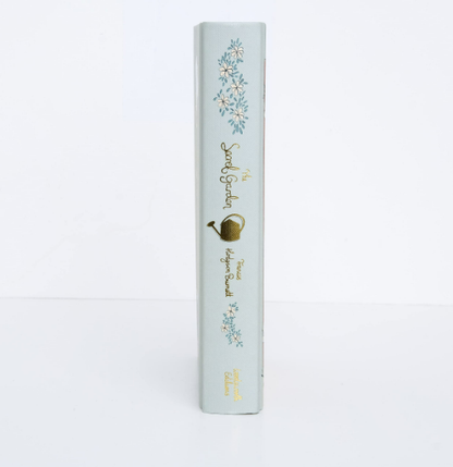 Light blue cylindrical product packaging with floral designs and text on a white background