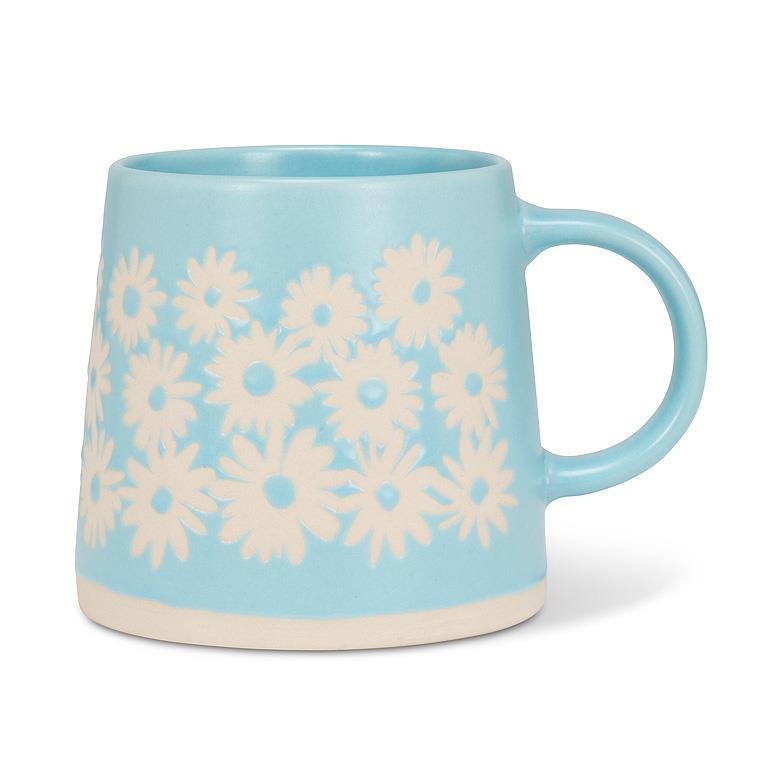 Light blue mug with white floral patterns on a white background