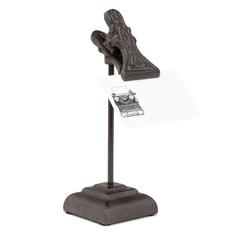Decorative clip with a typewriter design on a stand against a white background