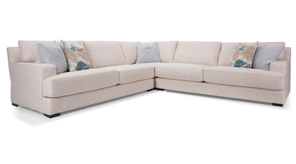 Beige sectional sofa with decorative pillows on a white background