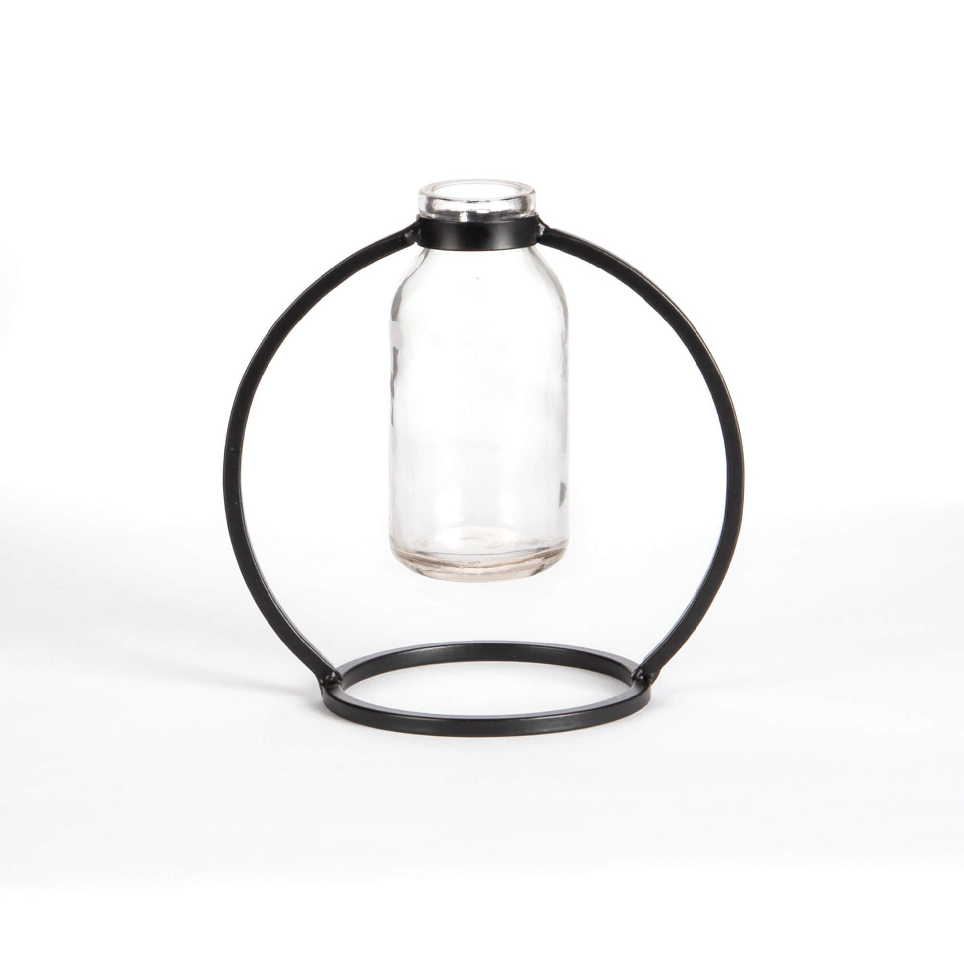 Glass bottle held by a black metal ring on a white background