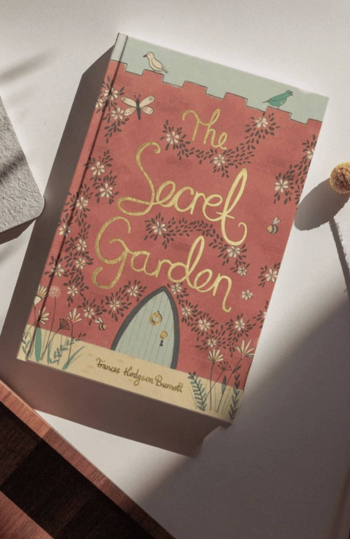 Book titled 'The Secret Garden' with floral design on a white surface