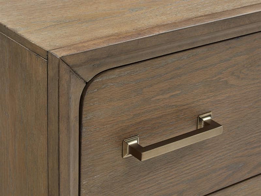 Wooden drawer with a metallic handle on a wooden cabinet.