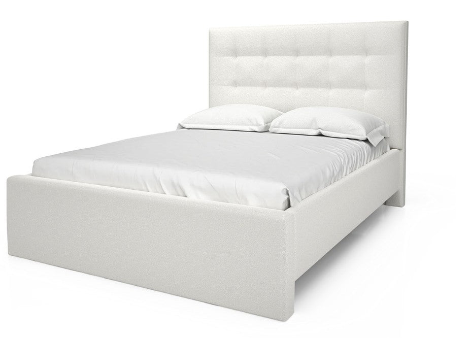 White upholstered bed with white bedding on a white background