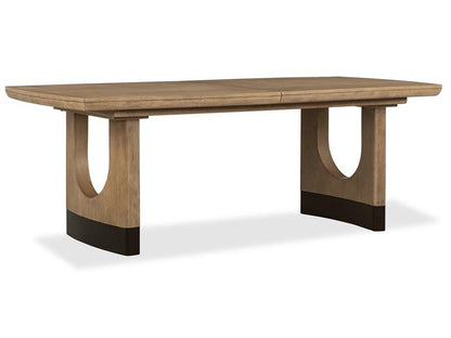 Wooden dining table with unique leg design on a white background