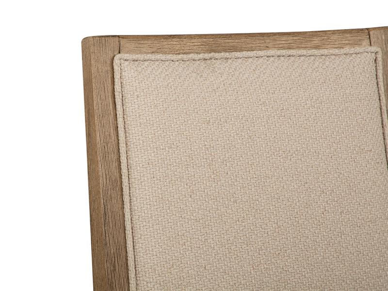 Close-up of beige chair upholstery with a wooden border on a white background