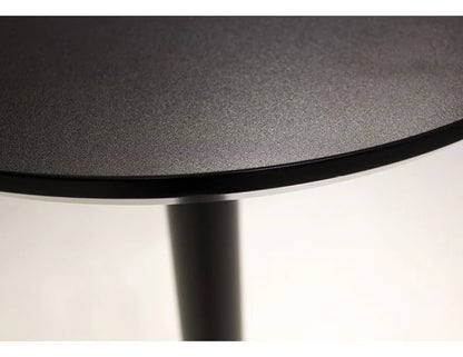 Close-up of a round black table with a white background