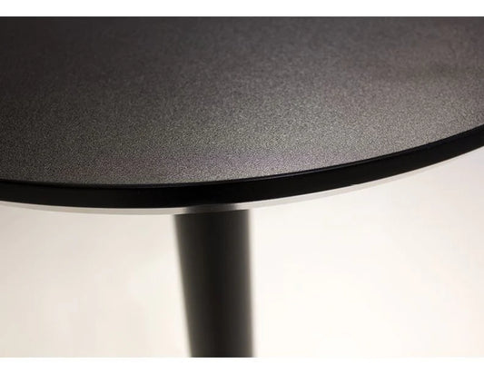 Close-up of a round black table with a white background