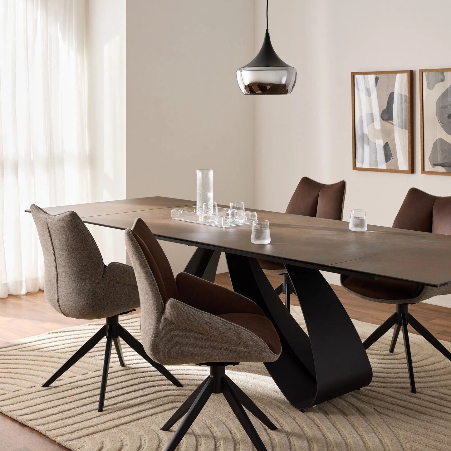 Modern dining room with a long ceramic  table and chairs.