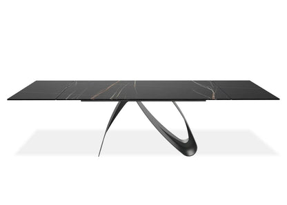 Modern black marble dining table with unique legs on a white background