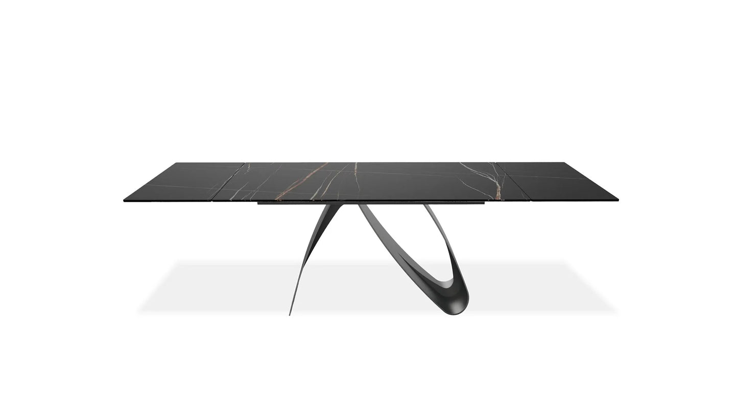 Modern black marble dining table with unique legs on a white background