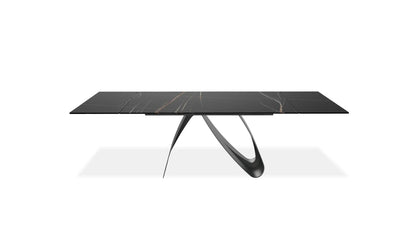 Modern black marble dining table with unique legs on a white background