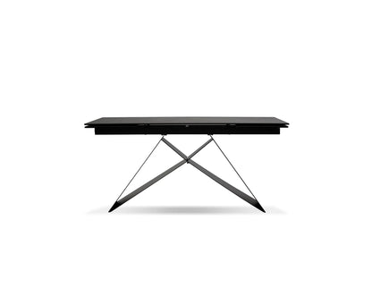 Black table with X-shaped metal legs on a white background