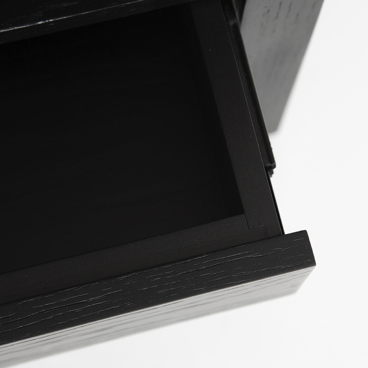 Close-up of a black wooden drawer on a white background