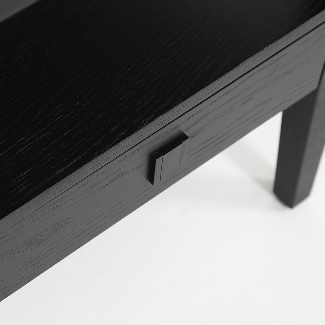 Black wooden desk with a power outlet on a white background