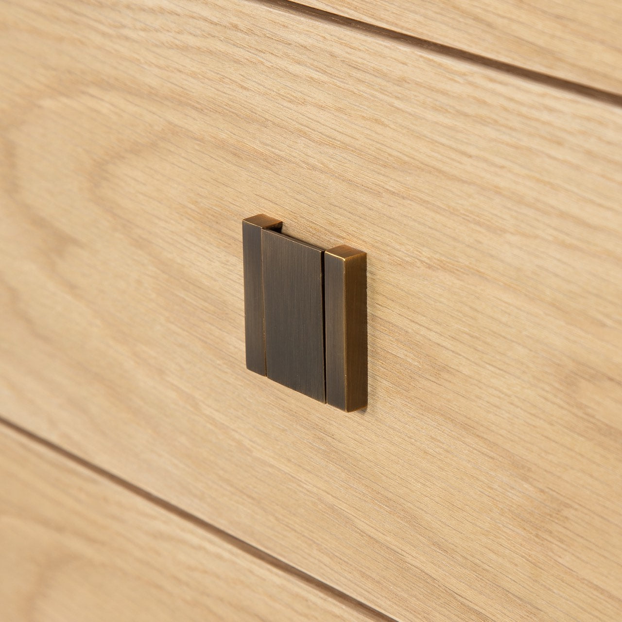 Wooden drawer with a metallic handle