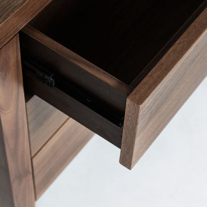 Wooden desk with an open drawer on a white background