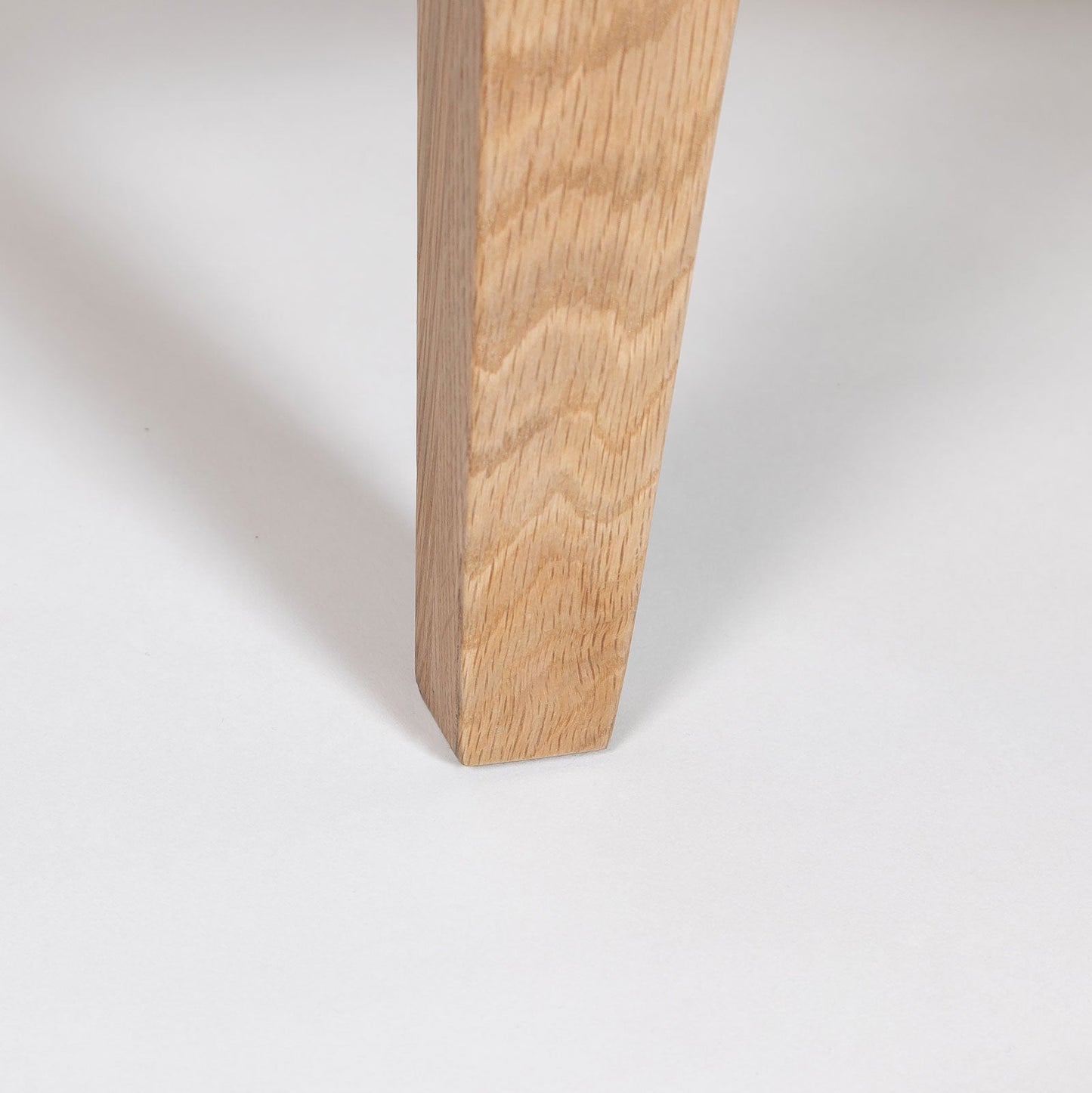 Close-up of a wooden leg on a white background