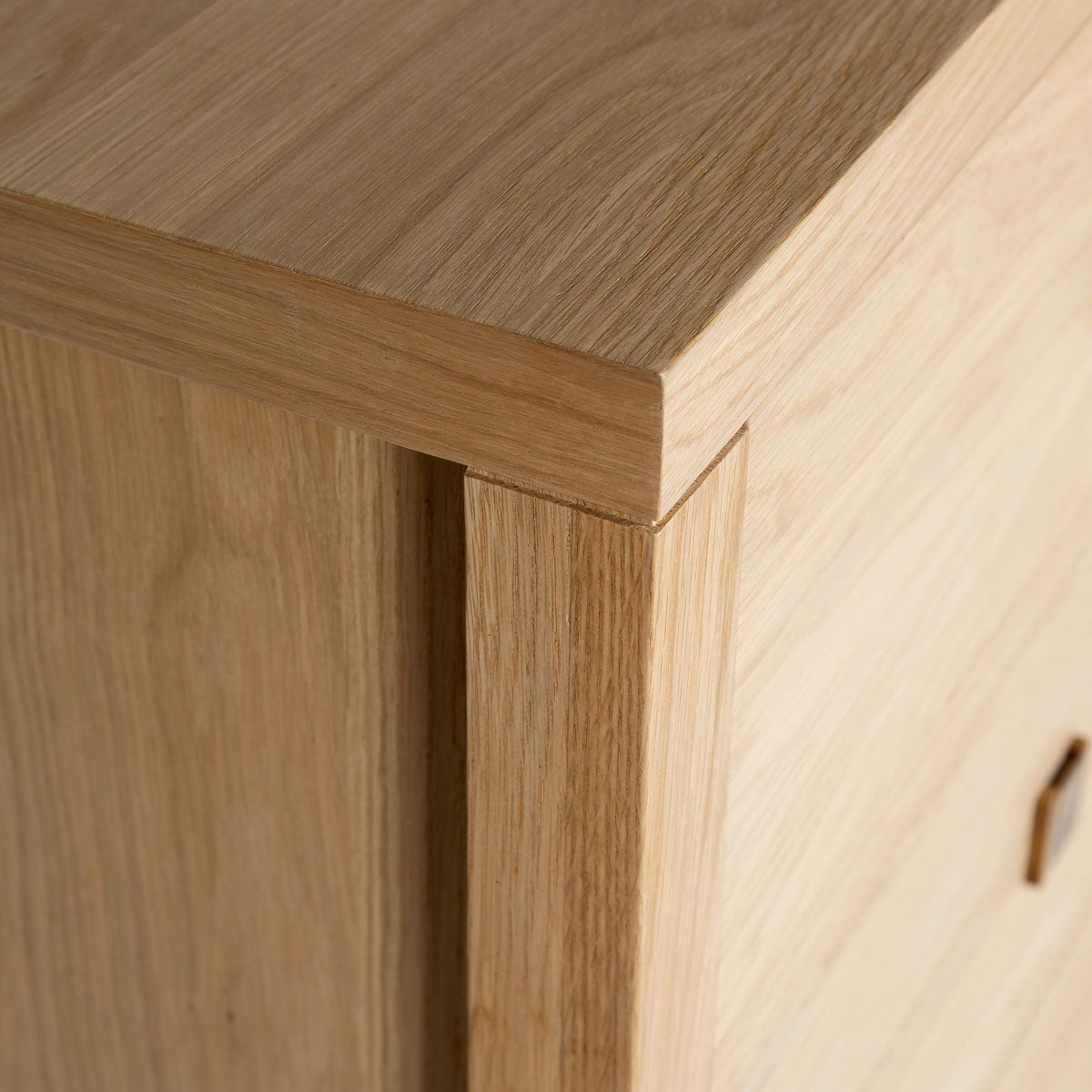 Close-up of a wooden cabinet corner with a smooth finish