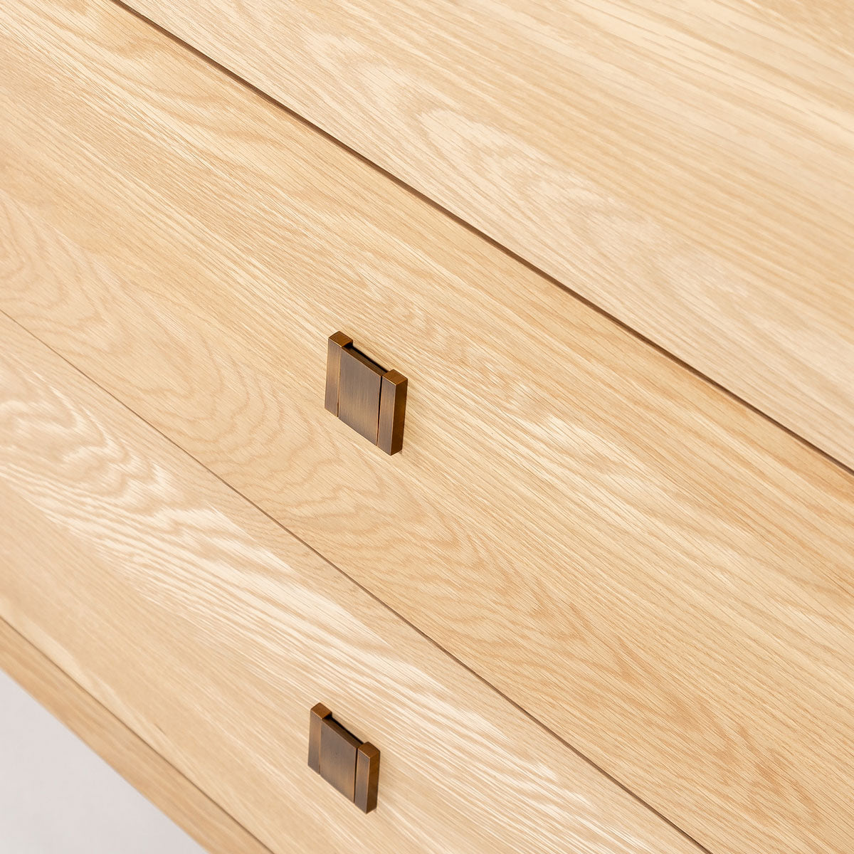 Close-up of a wooden surface with two square brown handles.