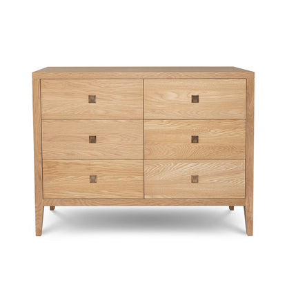 Wooden dresser with four drawers on a white background