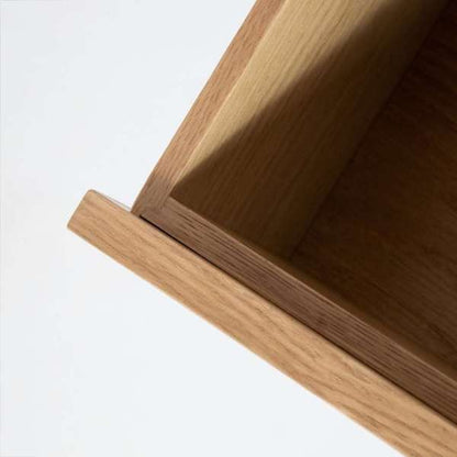 Close-up of a wooden shelf with a white background