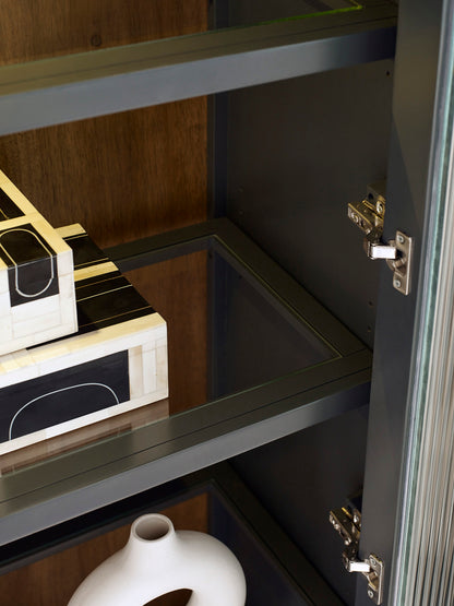 Close-up of a cabinet with a box inside, featuring gold and black design elements.