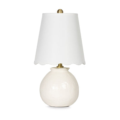White table lamp with a scalloped white shade on a white background