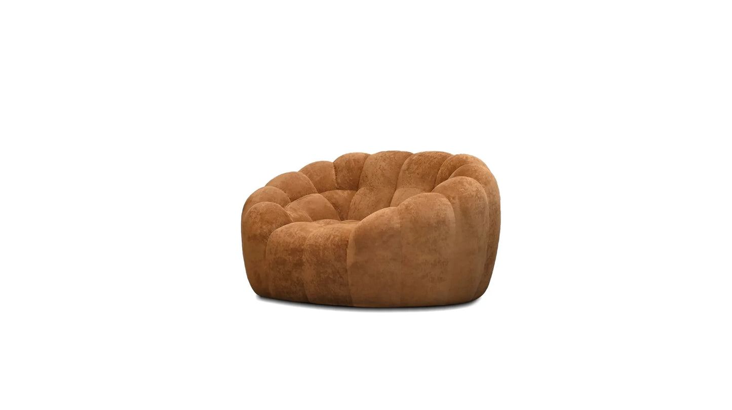 Brown quilted arm chair on a white background
