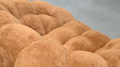 Close-up of brown textured fabric with a blurred gray background