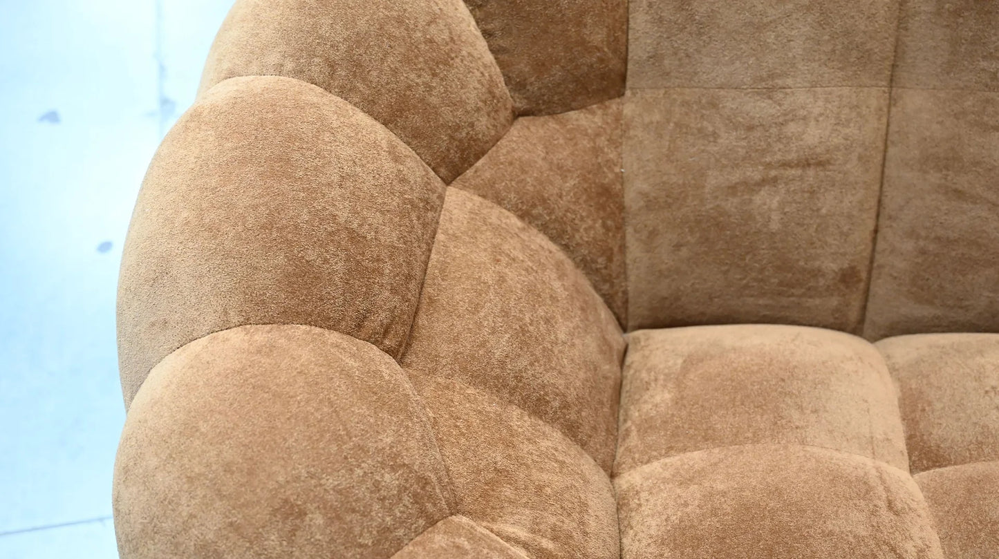 Close-up of a textured brown sofa with a blurred background