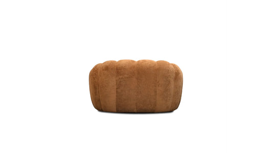 Brown quilted arm chair on a white background