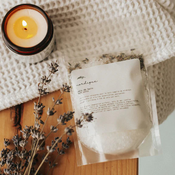 Product packaging with a candle and lavender on a textured surface